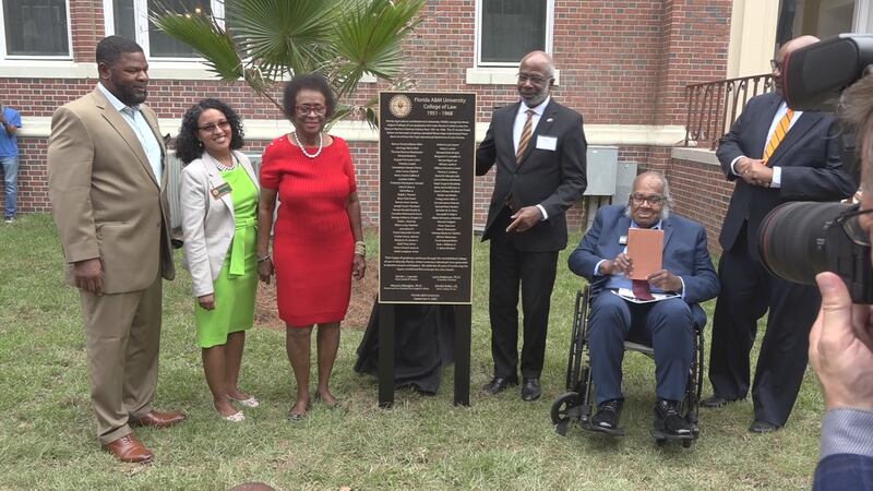 FAMU President Dr. Larry Robinson unveils a plaque to honor original FAMU Law School graduates.