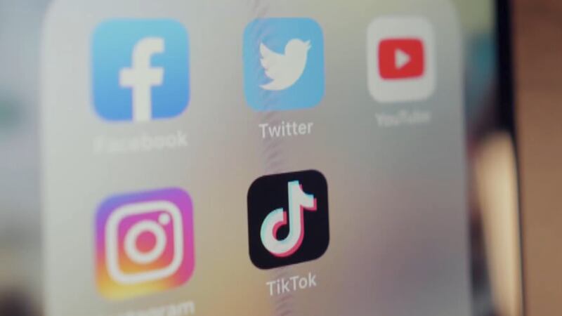 A phone showing popular social media accounts.
