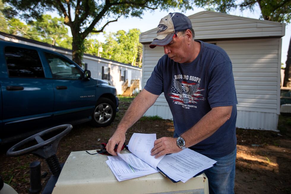 Scott Phillips, a homeowner and former employee at Lake Bradford Estates, sorts through a...