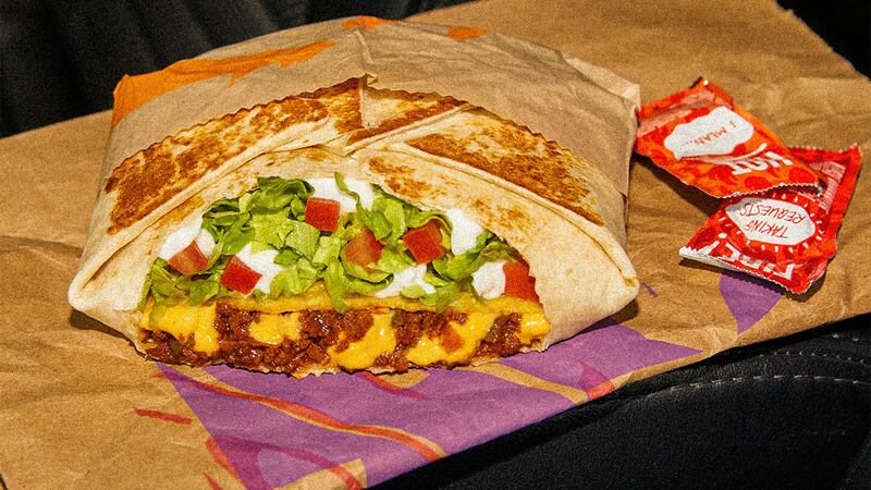 The Vegan Crunchwrap features vegan seasoned beef, cool vegan blanco sauce and warm vegan...