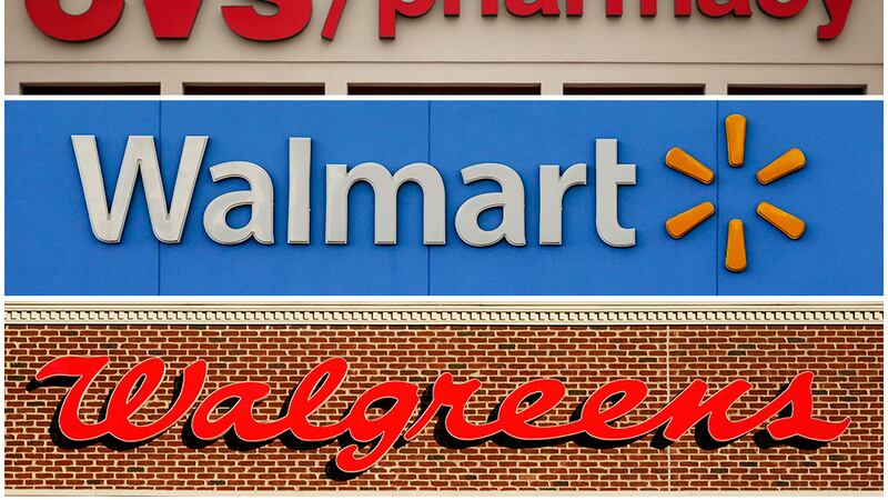 FILE - This undated combination of file photos show the signs of CVS, Walmart and Walgreens. A...