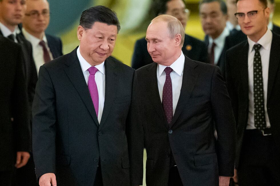 FILE - Chinese President Xi Jinping, left, and Russian President Vladimir Putin enter a hall...