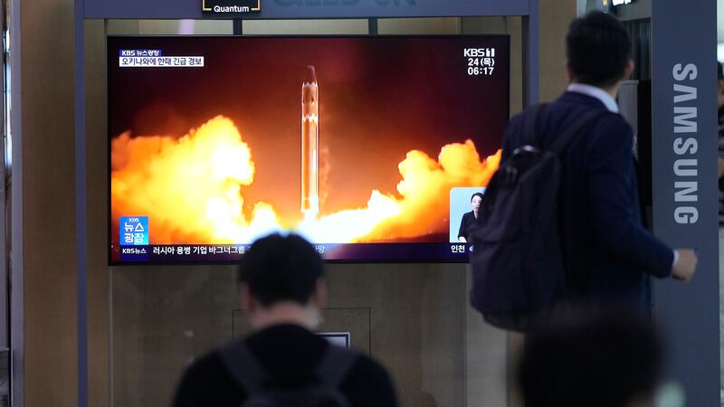 A TV screen shows a report of North Korea's rocket launch with a file image during a news...