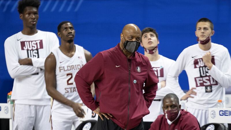 Florida State coach Leonard Hamilton and the Seminole bench watch as Georgie Tech takes a lead...