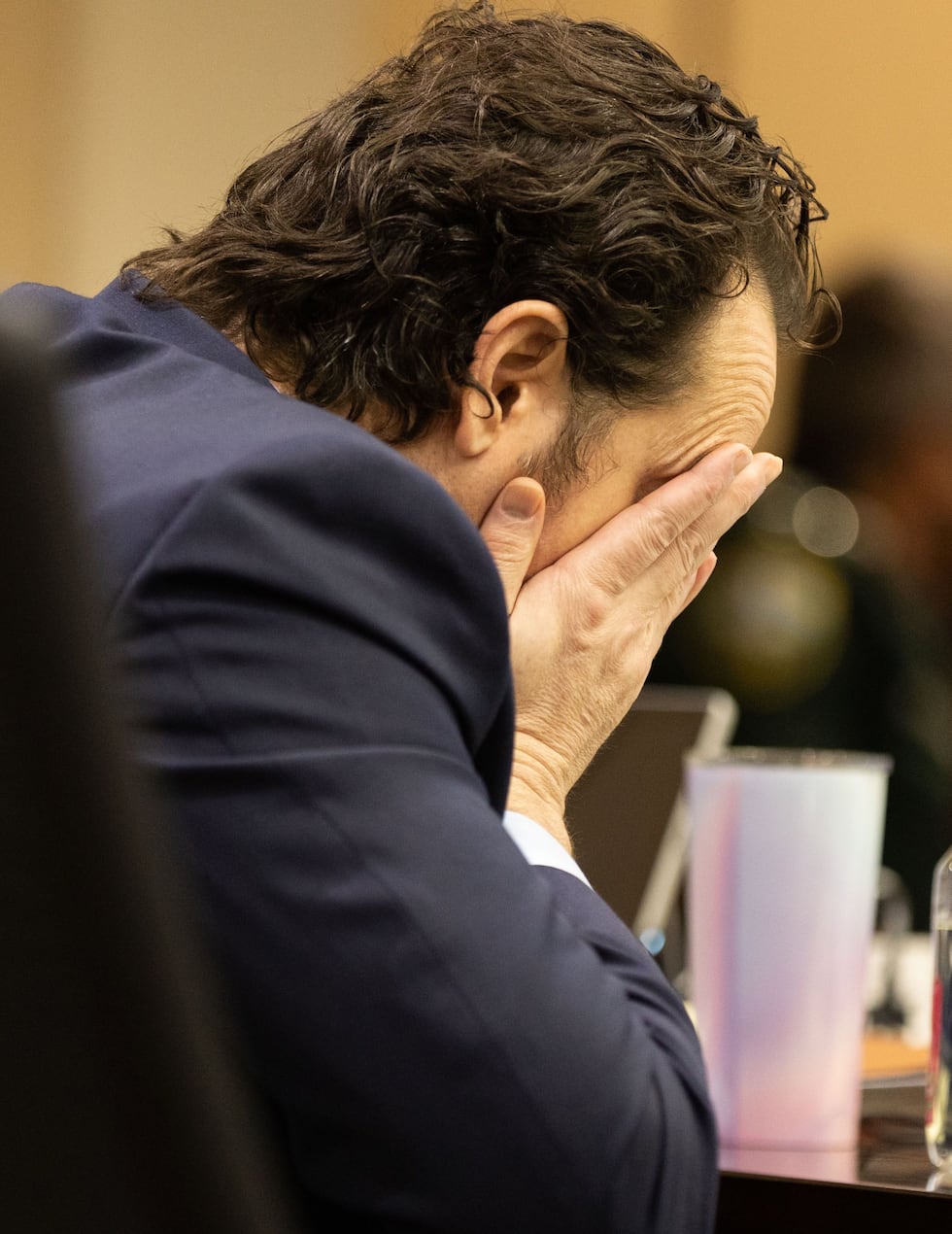 Charlie Adelson holding his head in his hands Monday as he's found guilty in murder for hire...