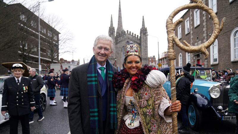 US actor Patrick Duffy poses for a photo with a performer, ahead of the St Patrick's Day...