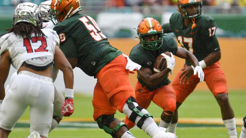 Florida A&M running back Bishop Bonnett (1) finds running room against Jackson State in the...