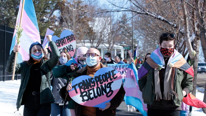 Advocates for transgender people march from the South Dakota governor's mansion to the Capitol...