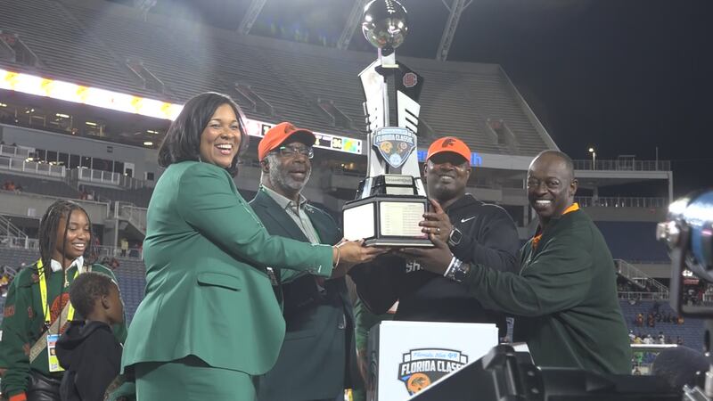 Florida A&M head coach Willie Simmons holds up Florida Classic Trophy after dominating Bethune...