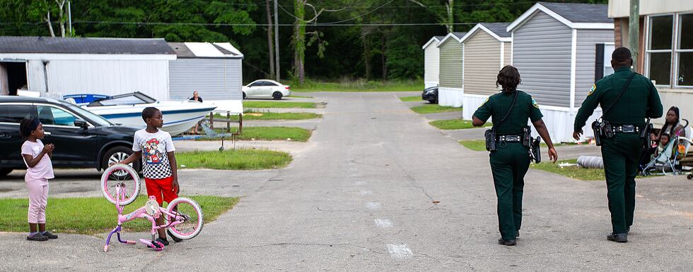 Leon County Sheriff's deputies walk through Lake Bradford Estates in response to a nearby...